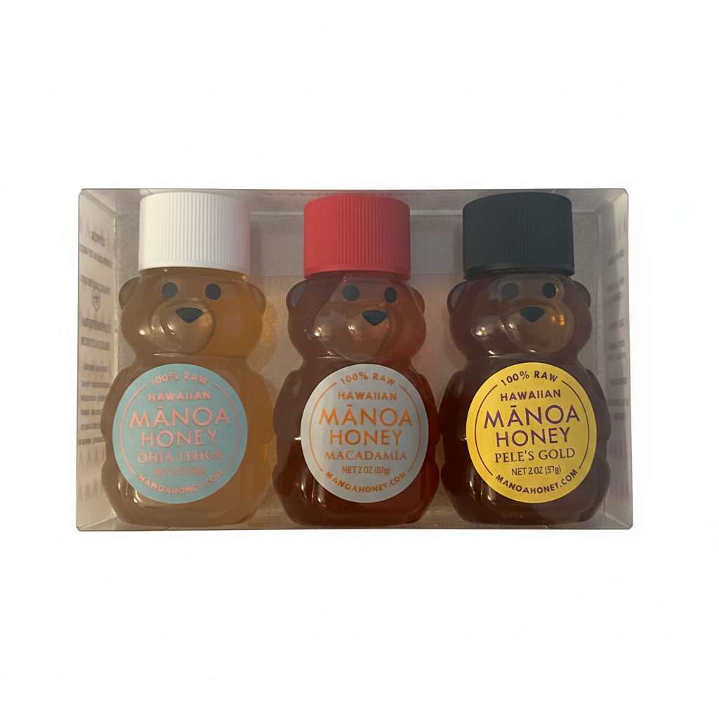 Three bear-shaped honey bottles with different colored caps and labels in a clear packaging box.