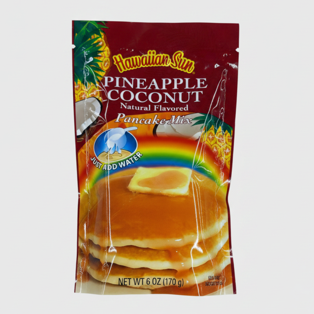 Packaged pineapple coconut flavored pancake mix on a white background