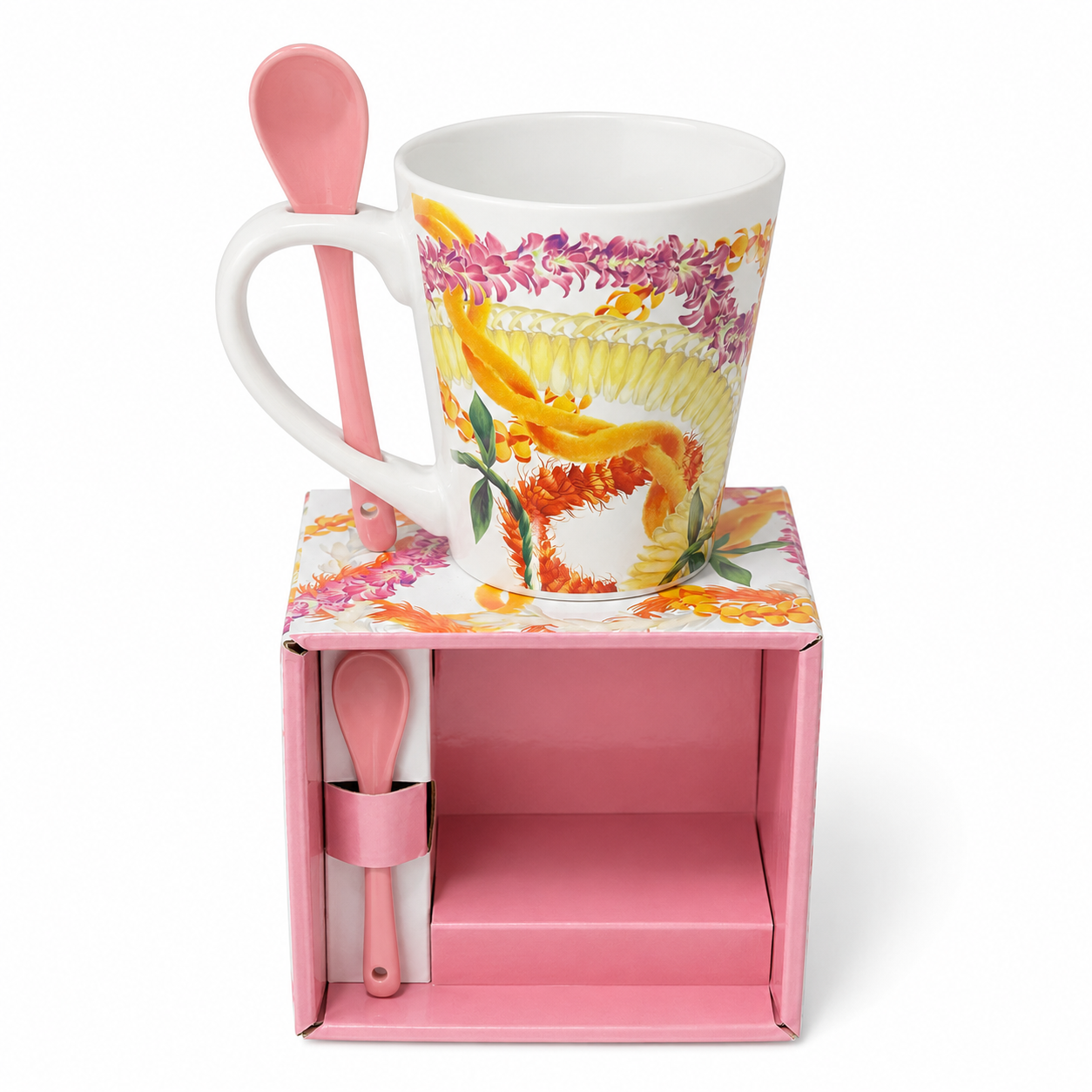 A white ceramic mug with a colorful floral and bird illustration, displayed on top of a pink gift box with a matching pink spoon and small container.