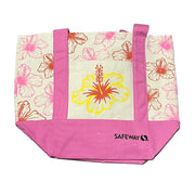Floral tote bag with pink accents and Safeway logo on a gray surface