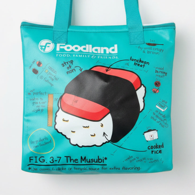 Teal tote bag with cartoon musubi character design on a white surface